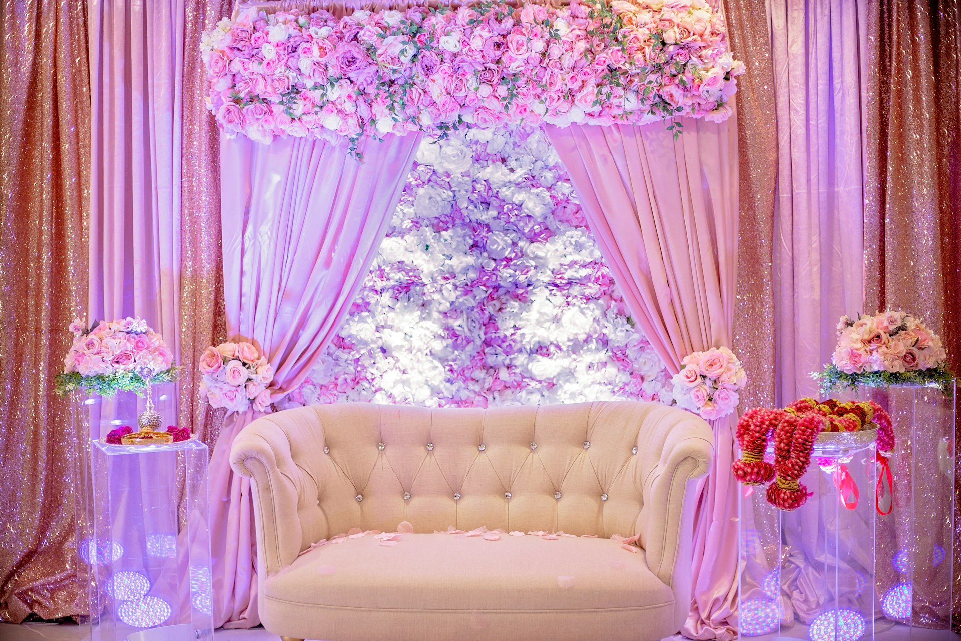a white couch sitting in front of a window covered in flowers